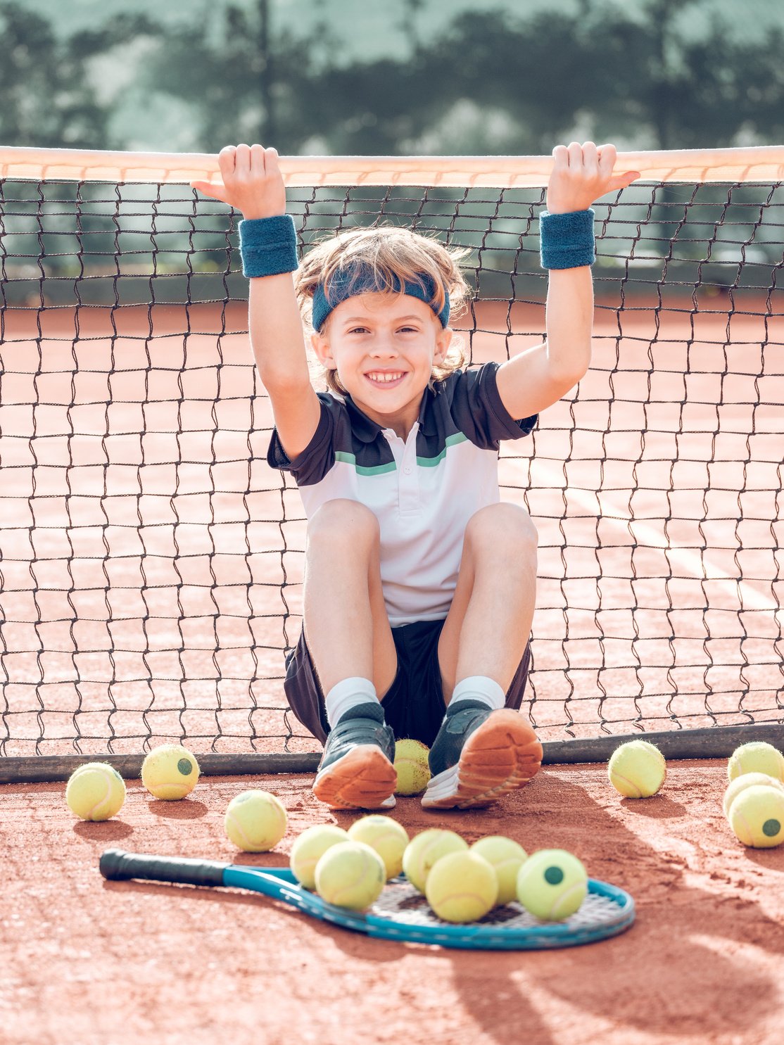 Positive Kid Tennis Player Having Fun on Court